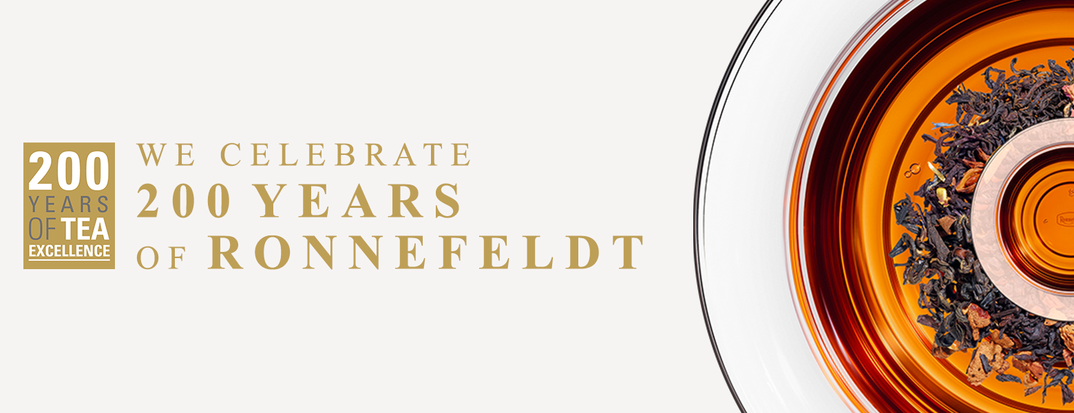 Anniversary banner with golden lettering “200 Years of Tea Excellence – We Celebrate 200 Years of Ronnefeldt” and a cup of black tea.