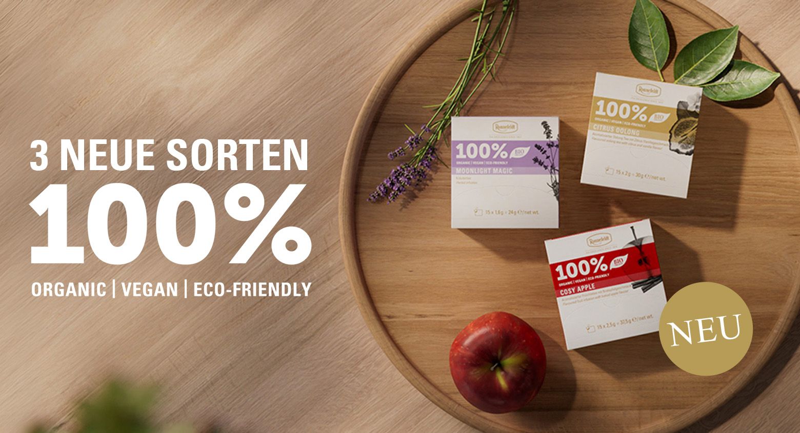 Banner mit drei neuen Teesorten auf Holztablett und Text „3 neue Sorten 100%“, mit „Neu“-Hinweis