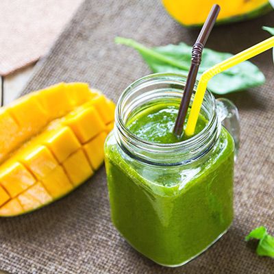 Grüner Smoothie im Glas mit Mangos