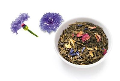 Schale mit Ronnefeldt Morgentau-Tee, daneben zwei blaue Kornblumen
