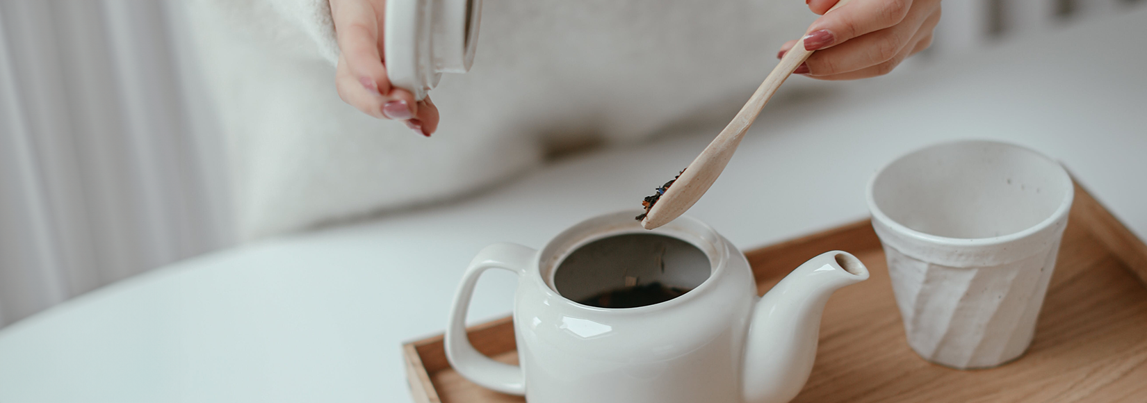 White porcelain teapot with white mug